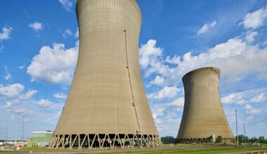 A 516-foot cooling tower stands unused beside its working twin at a Lake Erie nuclear plant, built for a second reactor that was canceled with the tower already finished, and the plant is now preparing to squeeze 213 more megawatts out of the one reactor it did get