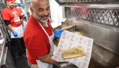 Frank Olivieri, owner of Pat's King of Steaks, with a chicken cheesesteak in 2024.