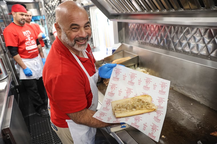 Frank Olivieri, owner of Pat's King of Steaks, with a chicken cheesesteak in 2024.