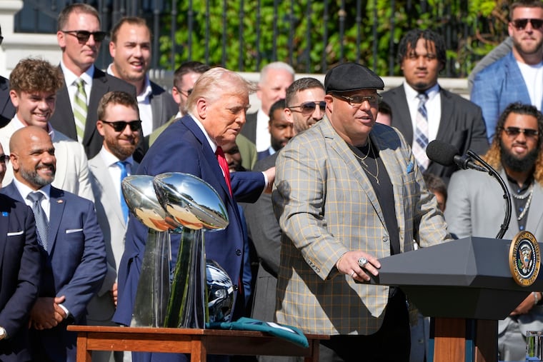 President Donald Trump allows the team's head of security Dom DiSandro to speak as he welcomes the Super Bowl champion Philadelphia Eagles NFL football team to the South Lawn of the White House, Monday, April 28, 2025, in Washington. (AP Photo/Mark Schiefelbein)
