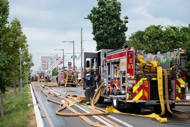 Firefighters work to put out a two alarm fire at a mixed use building on 2600 North American Street in Philadelphia on Monday, June 26, 2023.