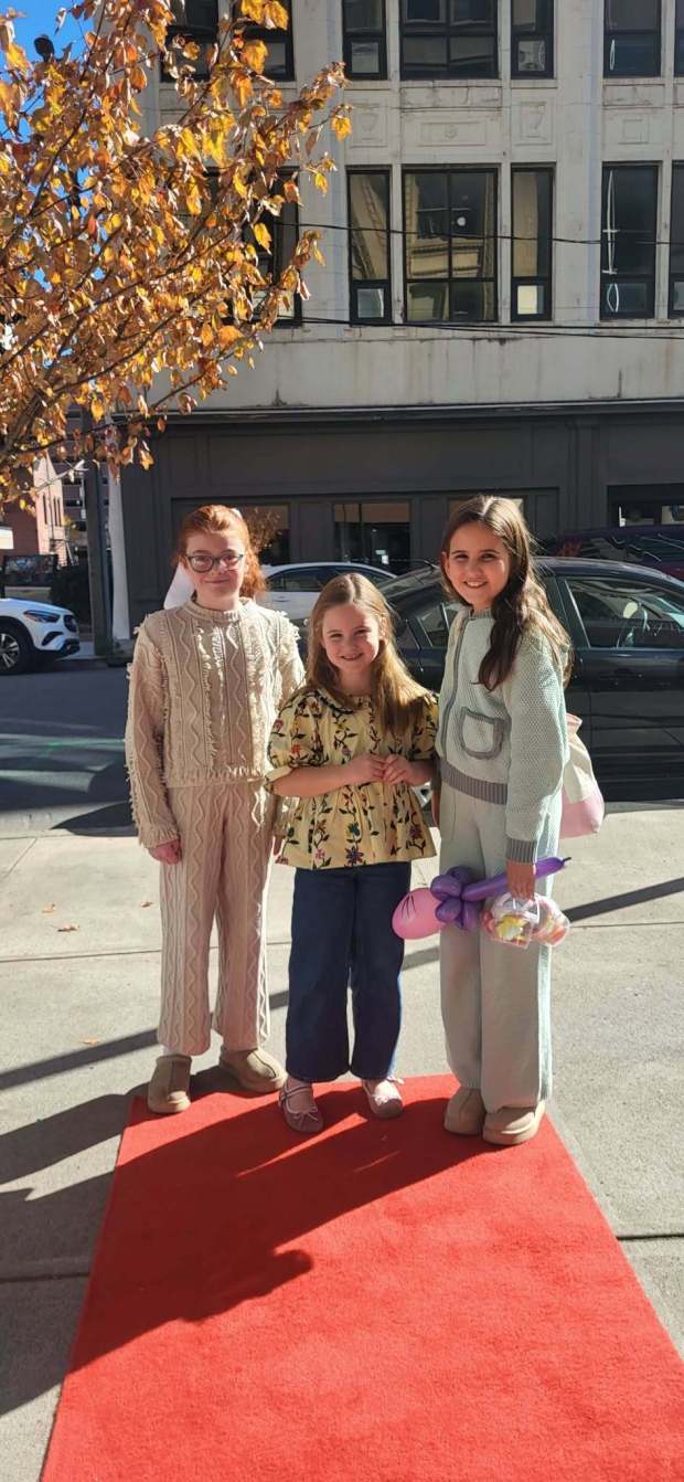 Betty Sweeney, 10, Delaney Davis, 6, and Whitney Davis, 10, take to the red carpet on Saturday, Oct. 24, 2026, as part of Scranton's Fall Festival activities held at the Over the Moon children's boutique. (GERI GIBBONS/STAFF PHOTO)