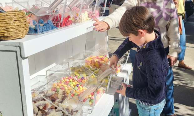 Over the Moon children's boutique provided a variety of activities during Saturday's fall festival, including a chance for youngsters to scoop up some candy to start the autumn season. The event is shown here on Sat. Oct. 24, 2026. (GERI GIBBONS/STAFF PHOTO)