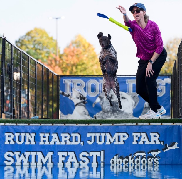 Luna, 2, jumps as owner Nikki O'Malley tosses a fetch toy in the water on Friday, Oct. 16, 2026, during Barktoberfest at Promenade Saucon Valley in in Upper Saucon Township. (April Gamiz/The Morning Call)