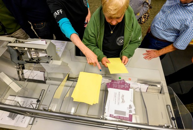 Lehigh County employees Janet Reilly and Andrea Lerner demonstrate how ballots are opened and sorted Thursday, Oct. 8, 2026, during the county voter registration office's first open house, at the government center in Allentown. The open house gave the public a look at where mail-in ballots are opened, processed and counted and the tabulation equipment used during elections, and learn more about how the equipment operates and how the election process comes together. (April Gamiz/The Morning Call)