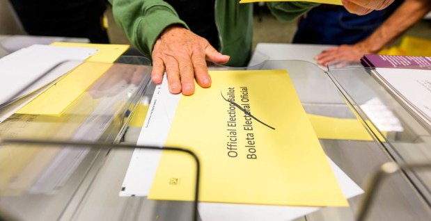 Lehigh County employees Janet Reilly and Andrea Lerner demonstrate how ballots are opened and sorted Thursday, Oct. 8, 2026, during the county voter registration office's first open house, at the government center in Allentown. The open house gave the public a look at where mail-in ballots are opened, processed and counted and the tabulation equipment used during elections, and learn more about how the equipment operates and how the election process comes together. (April Gamiz/The Morning Call)