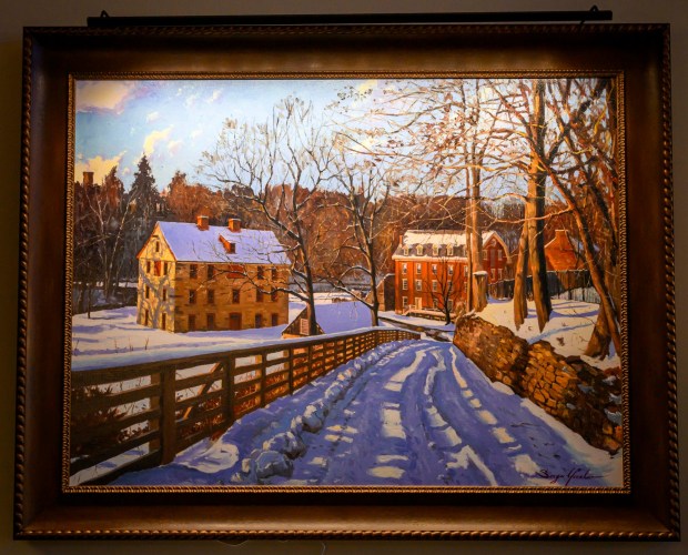 A painting of the 1761 Tannery, left, and 1869 Luckenbach Mill by Sergei Yaralov,  one of four recently installed in the main dining room of Kirkland Village, is seen Friday, Oct. 2, 2026, in Bethlehem. Residents donated money to purchase the art, part of a collection of over 800 pieces. The Tannery produced leather from the hides of butchered animals. The building contained vats for tanning and dyeing and a large, ventilated room for drying tanned hides. The Luckenbach Mill was built over the remains of an eighteenth-century water-powered grist mill. (April Gamiz/The Morning Call)