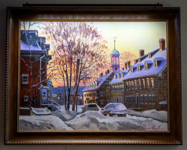 A painting of The 1742 Gemeinhaus, center, by Sergei Yaralov, one of four recently installed by the art commission in the main dining room of Kirkland Village, is seen on Friday, Oct. 2, 2026, in Bethlehem. Residents donated money to purchase the art, part of a collection of over 800 pieces. The 1742 Gemeinhaus is Bethlehem's oldest building. Its rooms were used for worship, trades, dining, and sleeping. It was designated a National Historic Landmark because of its association with naturalist David de Schweinitz. On the right in the painting is the Single Sisters' House, which housed a chapel, workshops, and dining for unmarried women. Women have been living in parts of the enlarged building continuously since 1752. (April Gamiz/The Morning Call)