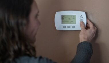 Sophie Alfonsi-Connaire turns down her thermostat at her home in Havertown, Pa. on Monday, Jan. 30. 2023. Starting Nov. 2, 2026, Pennsylvania households will be able to apply for LIHEAP to help pay for winter heating bills.