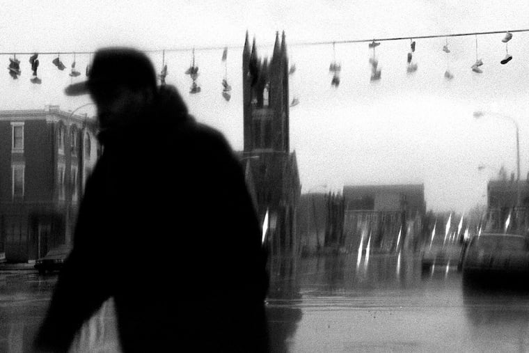 In this photo from March 23, 2000, a man walks through the rain in Northeast Philadelphia.