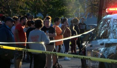Bystanders gathered outside the scene of a shooting in Erie, Pa., on Friday evening.