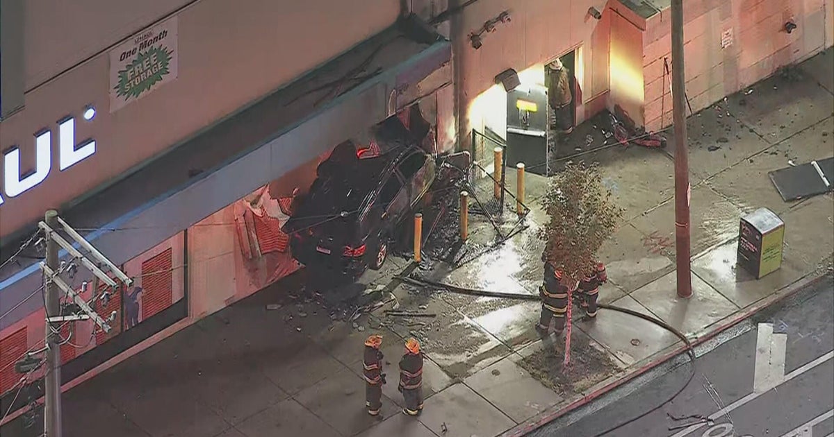 1 dead after car crashes into U-Haul building in Kensington, sparking large fire, police say