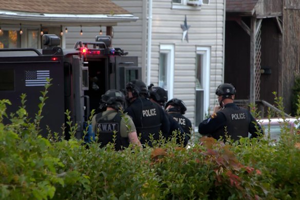 Police gather outside the scene of a shooting in Erie.