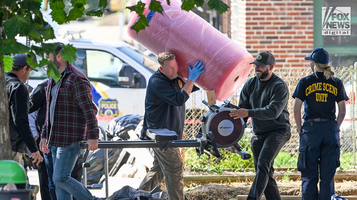 FBI agents bring out a rowing machine as they search for evidence in the home of Eugene Horsch on West Chew Avenue in Philadelphia on Monday, Oct. 5, 2026. Authorities are investigating the property after linking it to at least seven missing women. Eugene Horsch is the son of the late Raymond 
