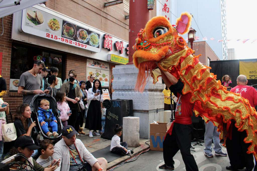 Members of Cheung’s Hung Gar Kung Fu martial arts school perform in a Chinese dragon outfit in front of a crowd