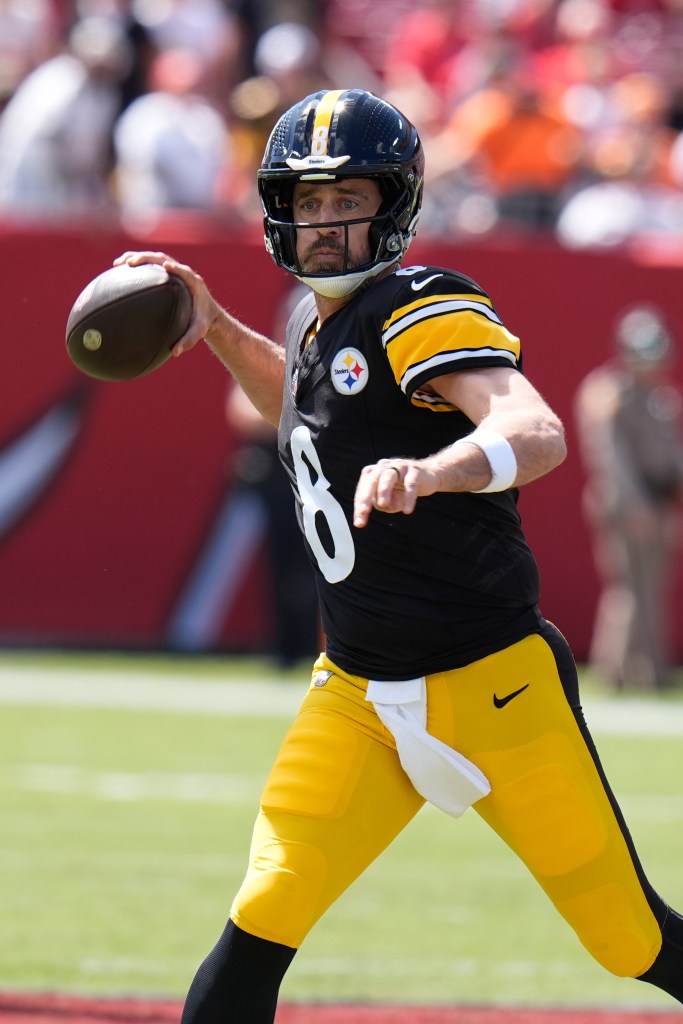 Pittsburgh Steelers quarterback Aaron Rodgers scrambles to pass during a game against the Tampa Bay Buccaneers.