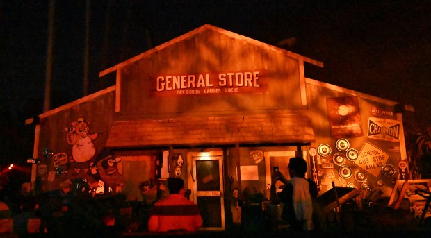 Visitors explore attractions during media night at Dorney Park's Halloween Haunt on Friday, Sept. 26, 2025, in South Whitehall Township. The event features haunted mazes, scare zones and live entertainment, along with signature thrill rides in the dark. (Amy Shortell/The Morning Call)