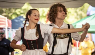 man and a woman dressed in traditional German clothing dancing