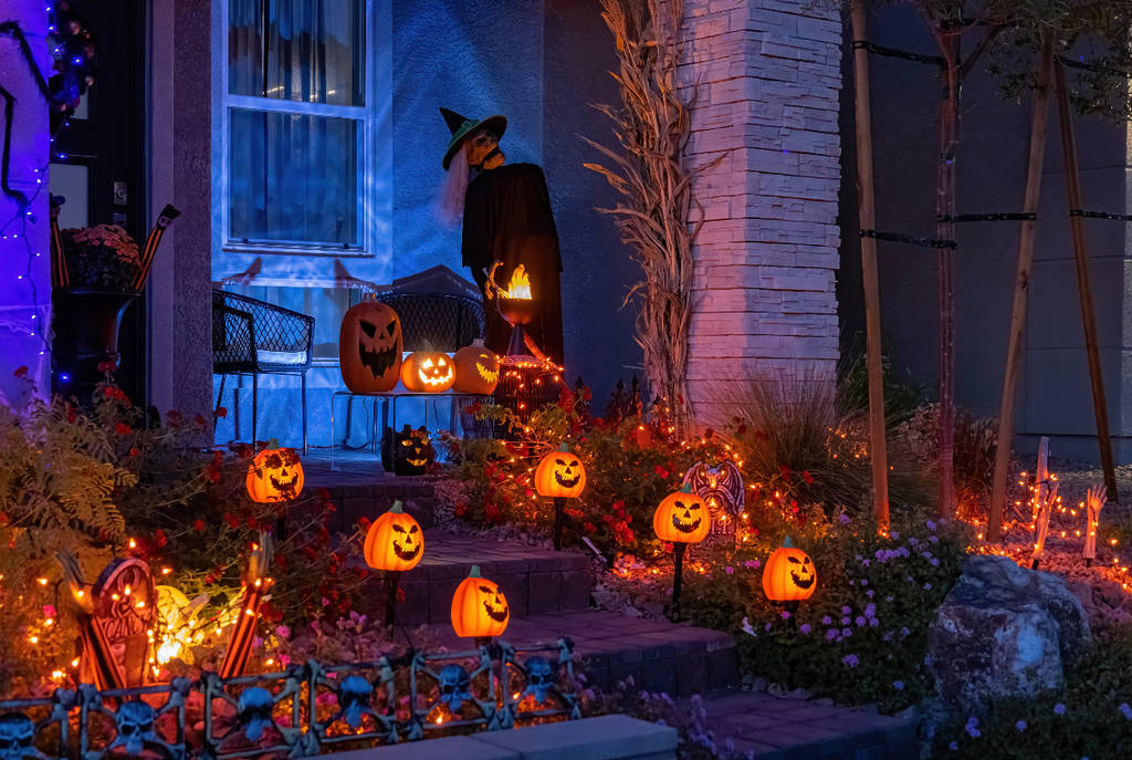 Image shows a home in Halloween decorations at night.