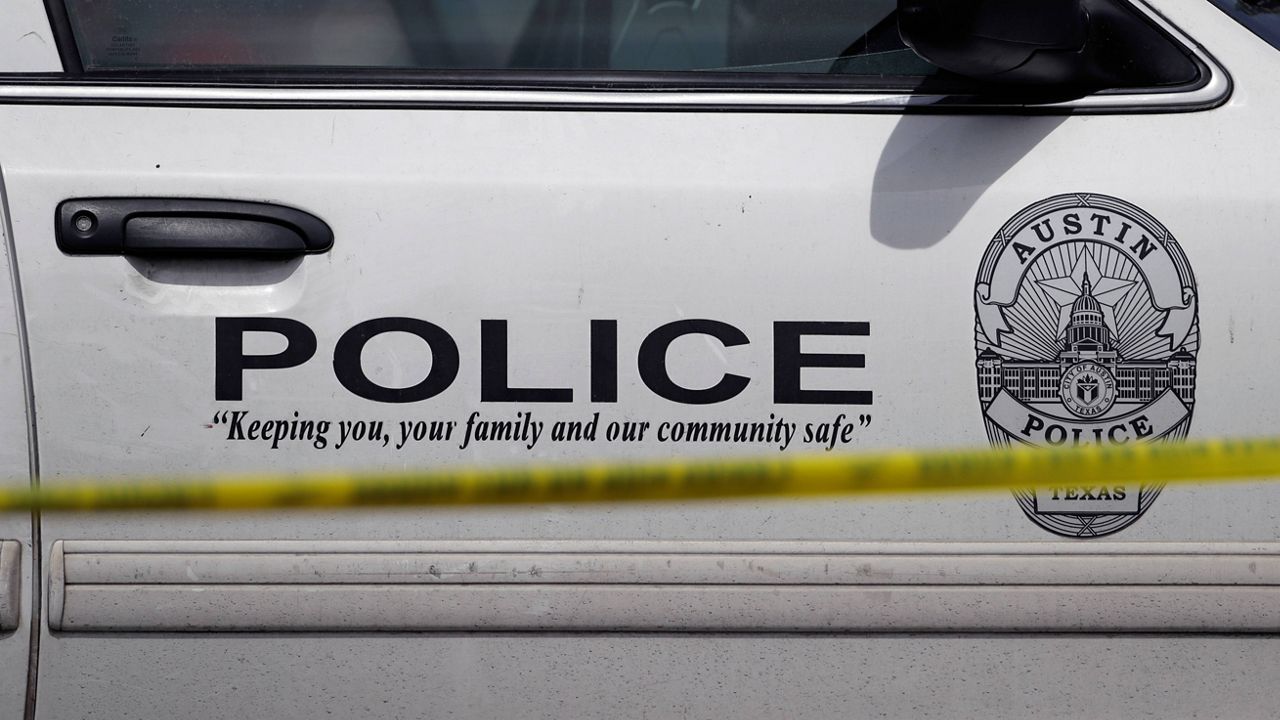 An Austin police car sits behind a police barrier. (AP Photo/Eric Gay)
