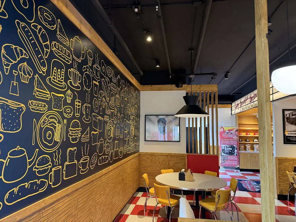 Artworks cover the walls at the Breakfast Brothers in downtown Arlington, Texas, a destination breakfast restaurant, seen Oct. 25, 2025.