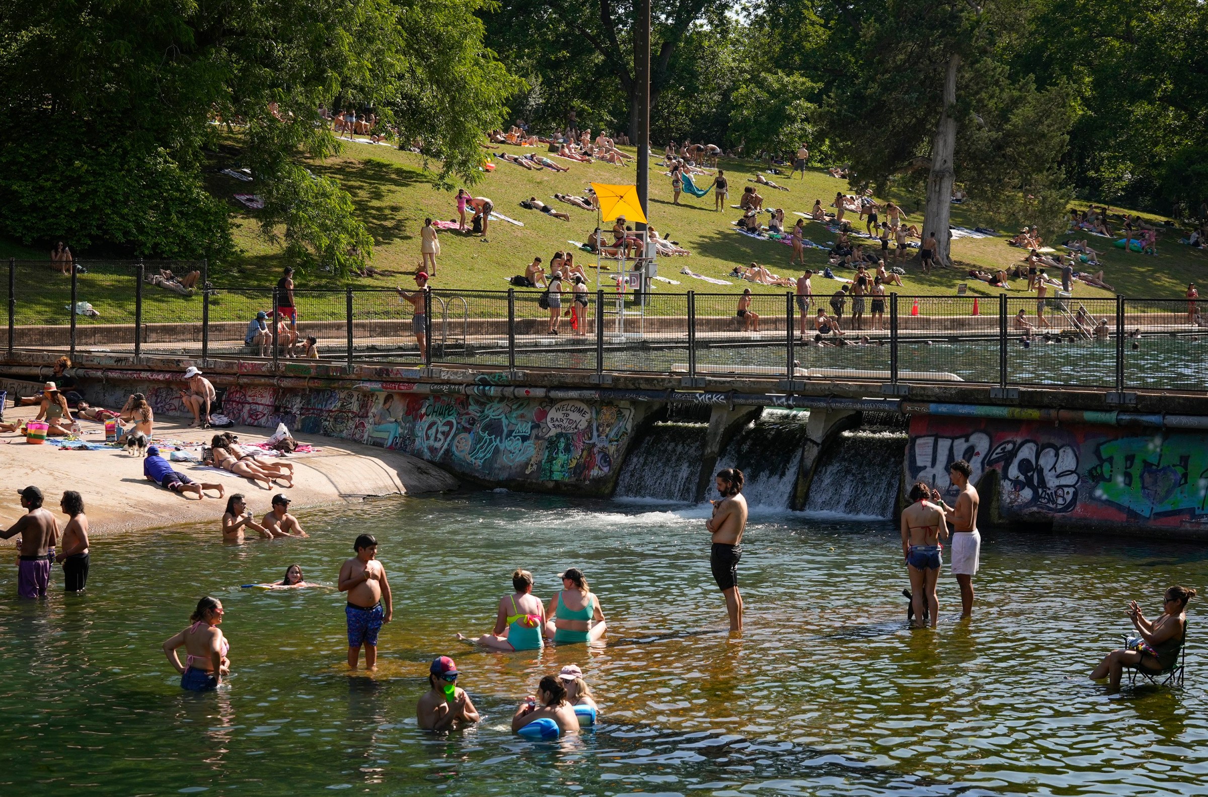 AUSTIN, TEXAS - MAY 13: People cool off in Barking Springs just downstream of Barton Springs Pool on a hot afternoon Tuesday May 13, 2025. If you head to the pool, make sure to assign a person to watch all the swimmers in your group. (Austin American-Statesman Photo Staff/ Connecticut Post via Getty Images)