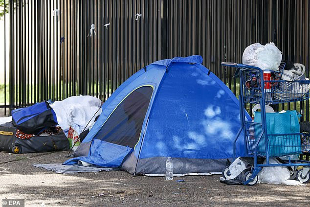 A homeless person sits inside a tent in Austin, Texas, USA, 22 April 2024