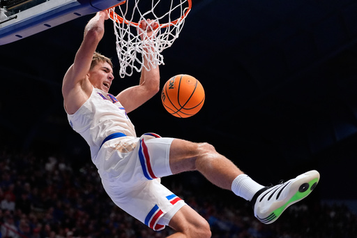 Kansas guard Kohl Rosario dunks the ball during the first half of an NCAA college basketball game against Texas A&M Corpus Christi, Tuesday, Nov. 11, 2025, in Lawrence, Kan. (AP Photo/Charlie Riedel)