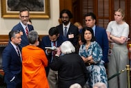 Texas Sen. Carol Alvarado, D-Houston, right, huddles with other democrat senators and staff...