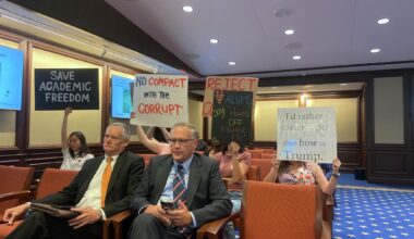 Silent protesters urge University of Texas System Board of Regents to reject the compact offer the President Donald Trump Administration sent the system's flagship school at the Nov. 19 board meeting.