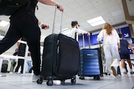 Passengers make their way through Terminal C at DFW International Airport on Friday, Nov. 7,...