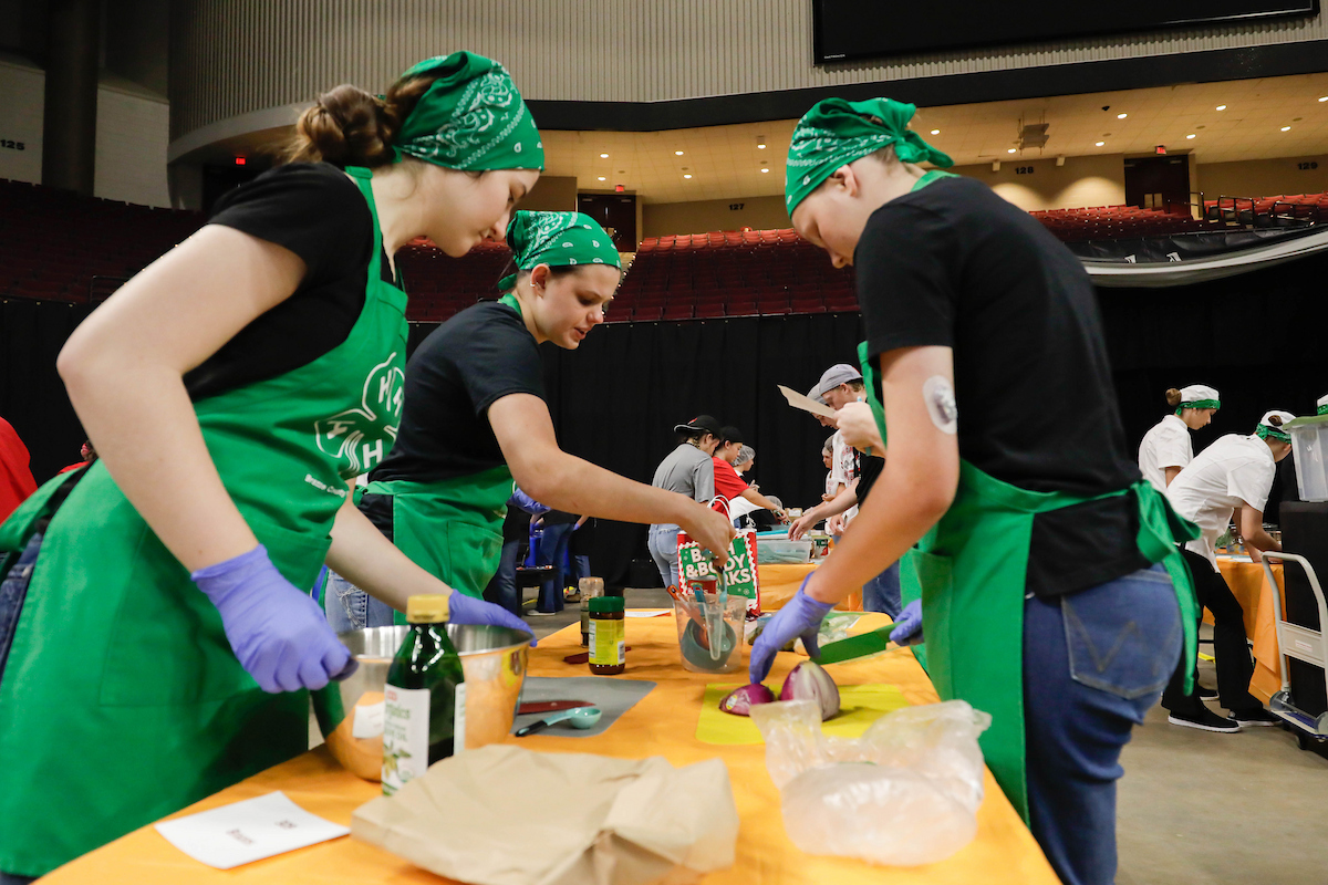 A group of individuals taking part in the 4-H cooking challenge.