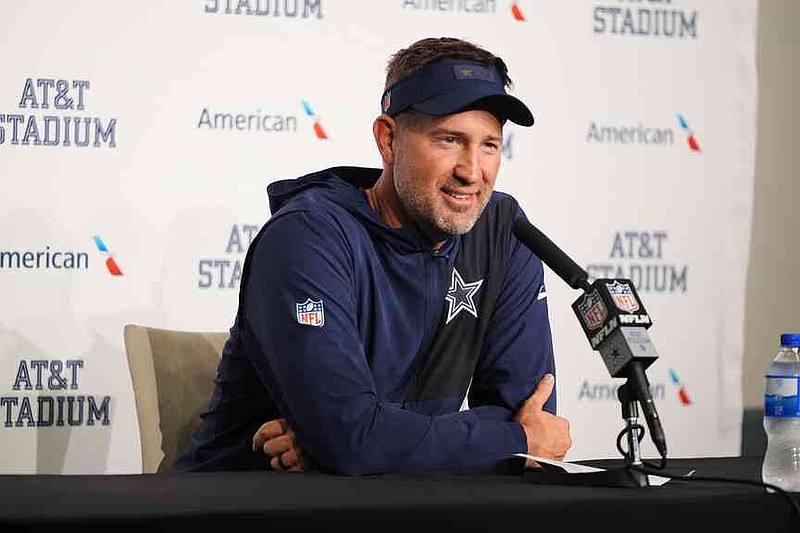 Dallas Cowboys head coach Brian Schottenheimer answers questions after an NFL football game against the Philadelphia Eagles, Sunday, Nov. 23, 2025, in Arlington, Texas. (AP Photo/LM Otero)