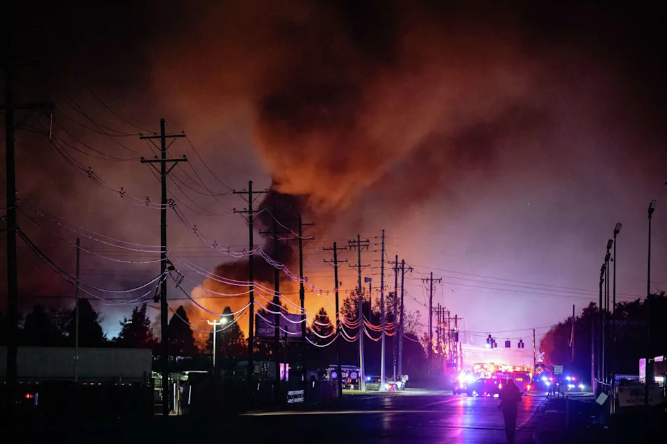 Plumes of smoke rise from the area of a UPS cargo plane crash Tuesday at Louisville Muhammad Ali International Airport in Kentucky. At least nine people were killed and 11 more hurt. (Jon Cherry/Associated Press)