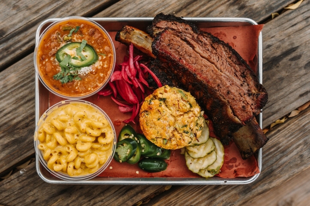 A plate of food with brisket and sides