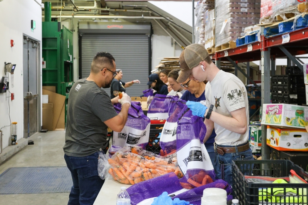 New Braunfels Food Bank volunteers load pre-made bags of produce for community members in need.