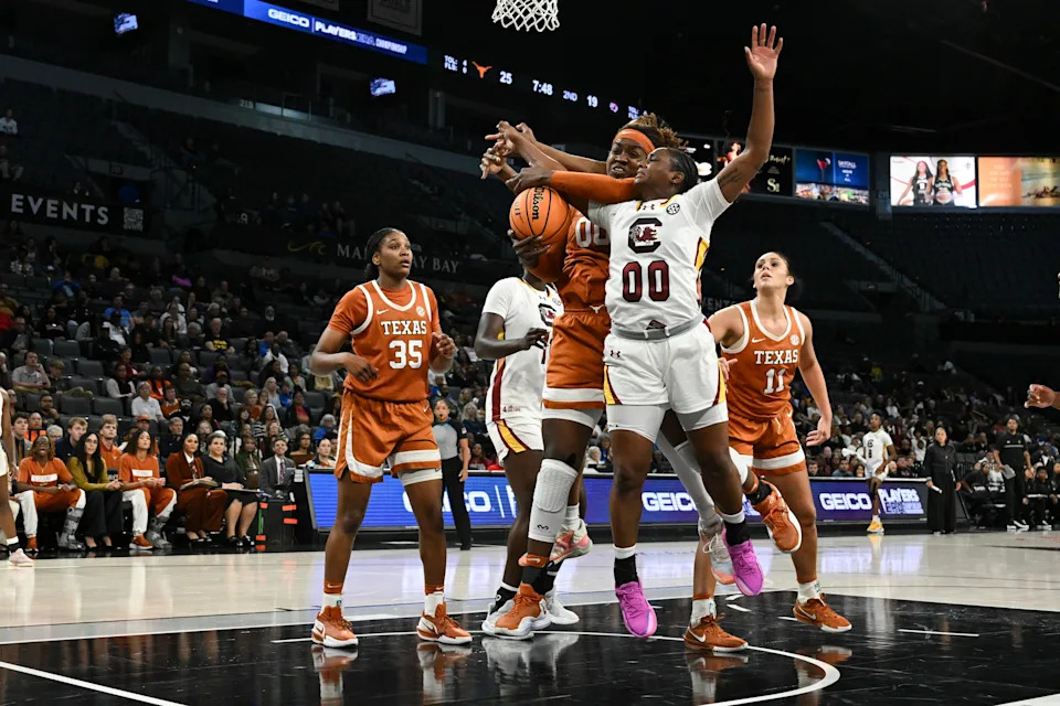 Texas' Kyla Oldacre and South Carolina's Ta'Niya Latson battle for a rebound in Players Era Championship final.