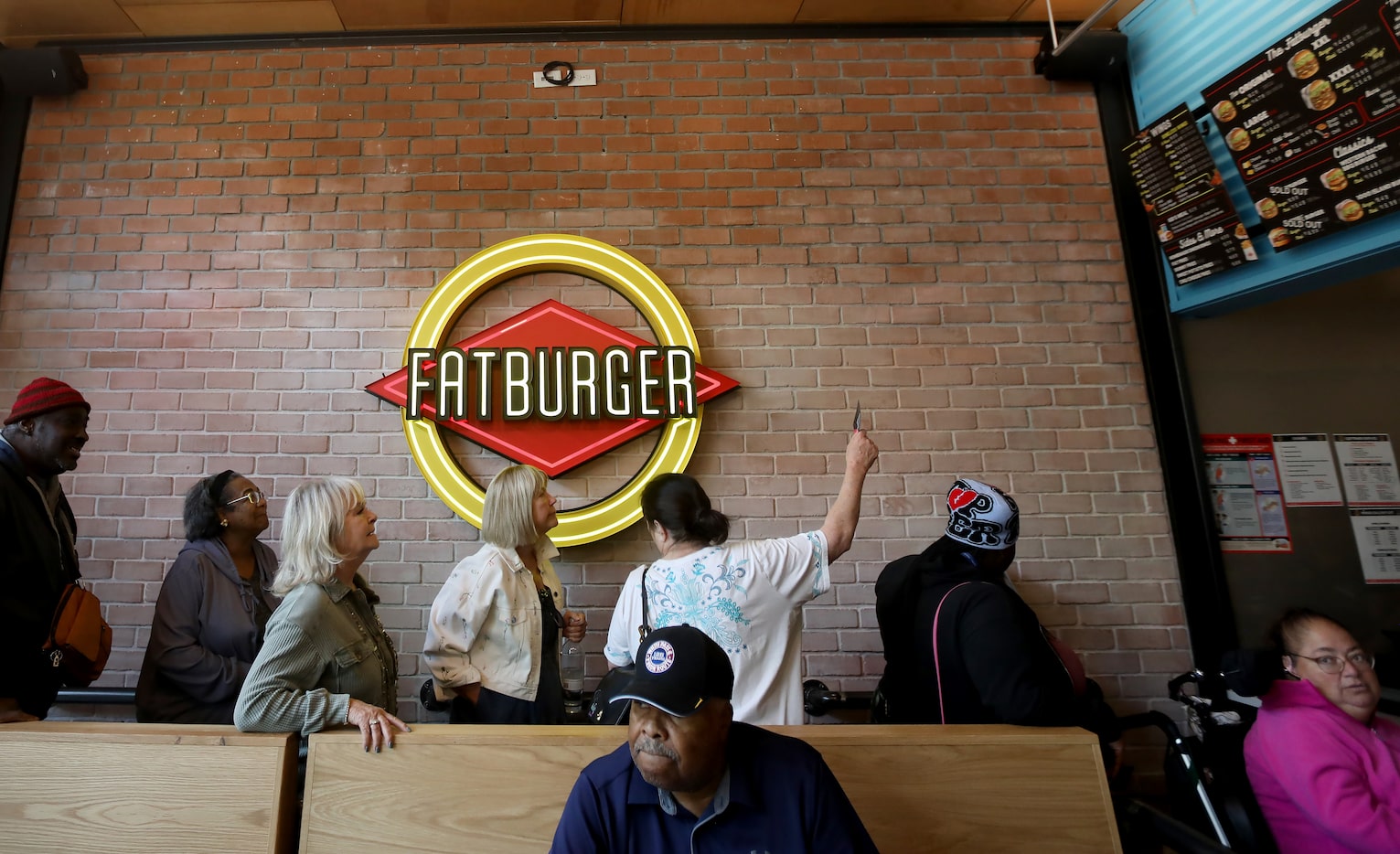 People line up to order as Dallas' first Fatburger opened in Dallas on Nov. 22, 2025.