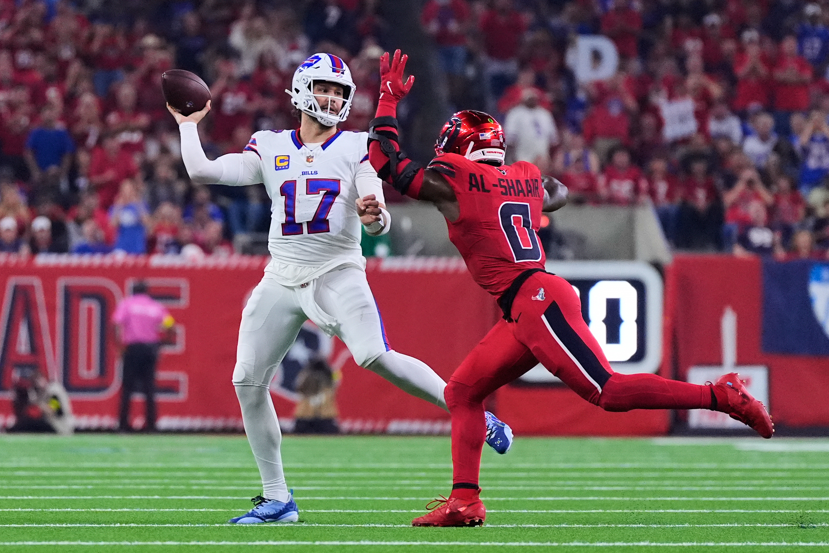 Buffalo Bills quarterback Josh Allen (17) throws a pass under pressure from Houston Texans linebacker Azeez Al-Shaair (0) in the first half of an NFL football game Thursday, Nov. 20, 2025, in Houston. (AP Photo/Ashley Landis)