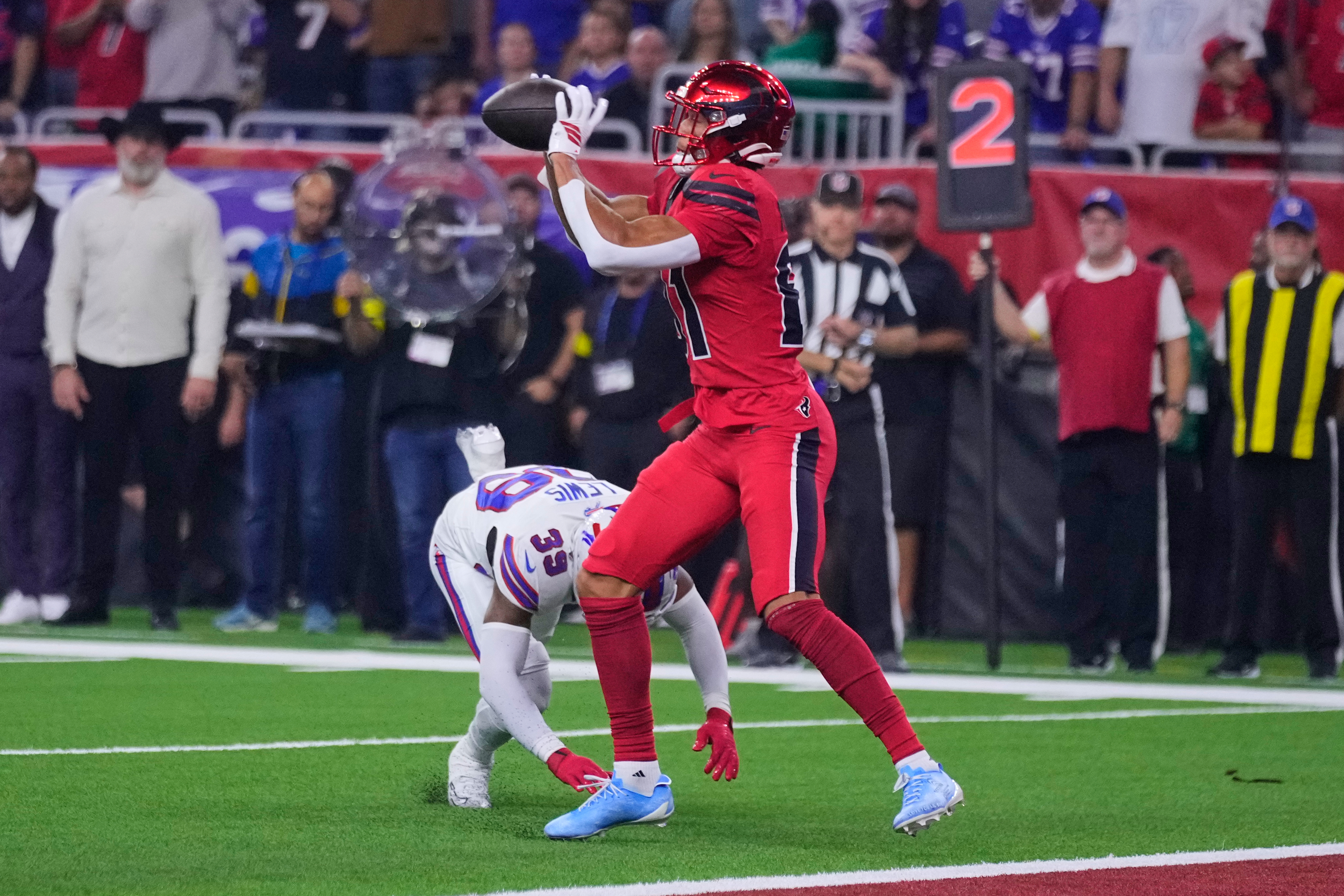 Houston Texans wide receiver Jayden Higgins (81) catches a touchdown pass in front of Buffalo Bills cornerback Cam Lewis (39) in the first half of an NFL football game Thursday, Nov. 20, 2025, in Houston. (AP Photo/Eric Christian Smith)