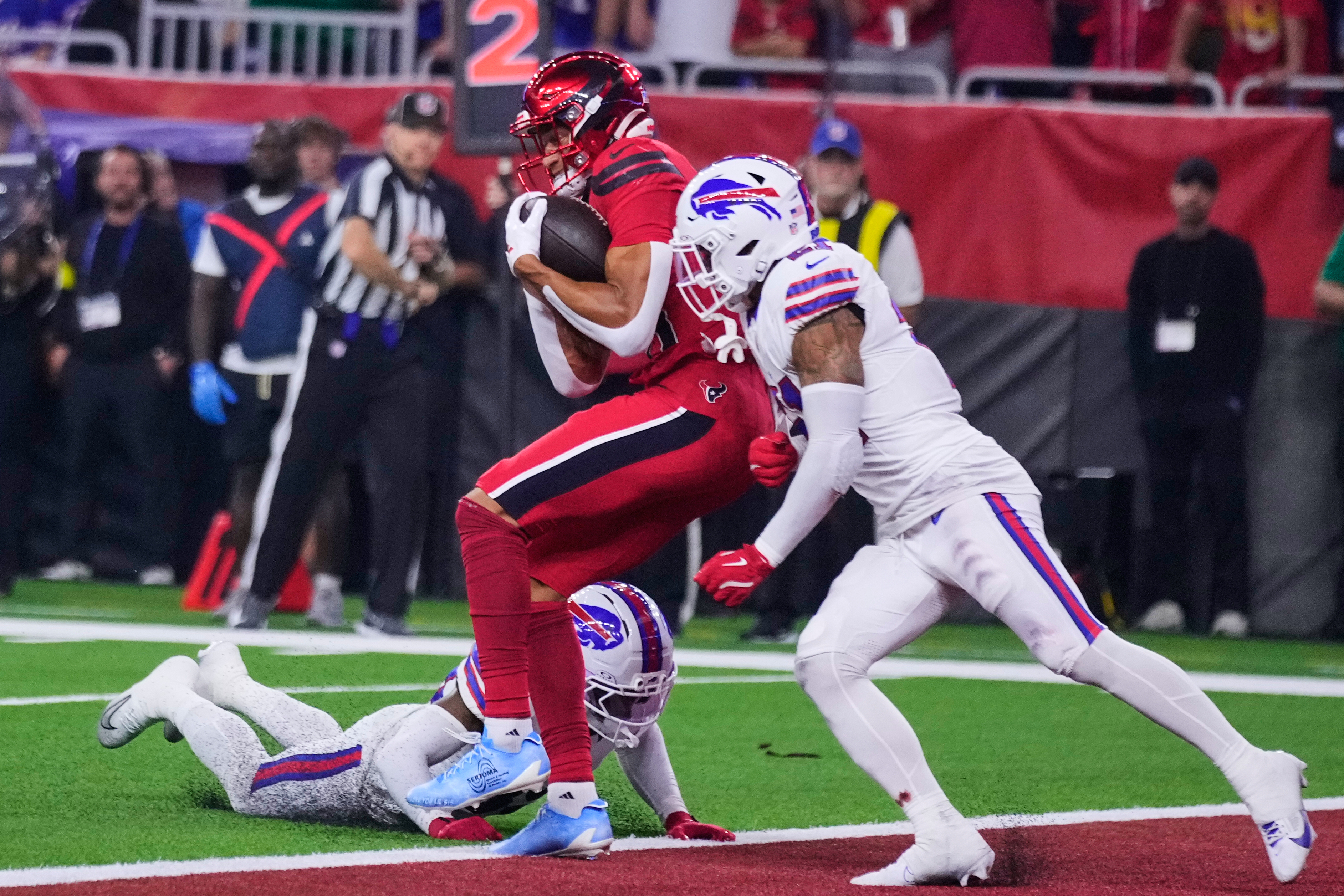 Houston Texans wide receiver Jayden Higgins (81) catches a touchdown pass as Buffalo Bills' Cam Lewis, bottom left, and Jordan Poyer, right, defend in the first half of an NFL football game Thursday, Nov. 20, 2025, in Houston. (AP Photo/Eric Christian Smith)