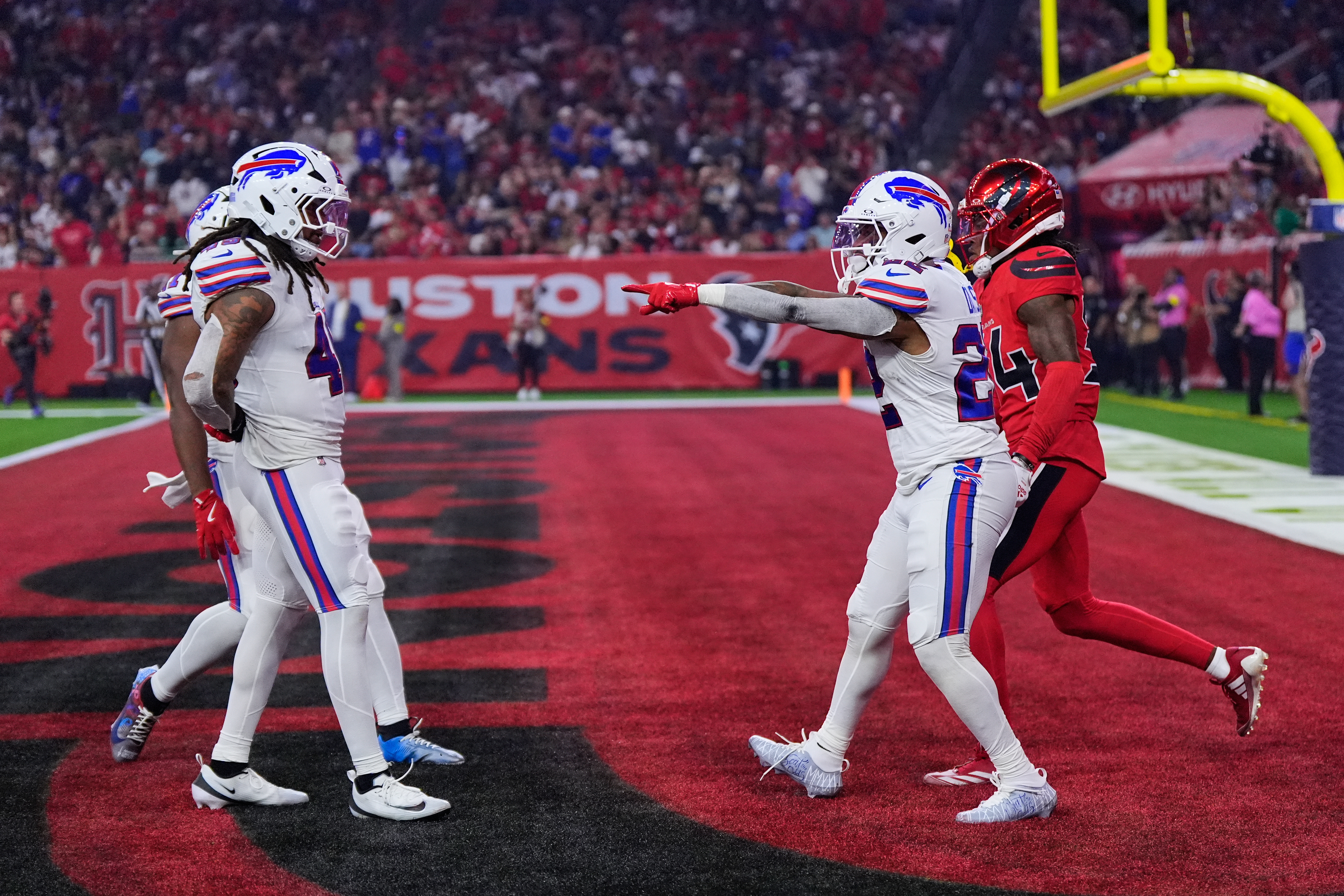 Buffalo Bills' Ray Davis, right front, celebrates with teammates in front of Houston Texans' Ajani Carter, right rear, after Davis returned a kickd-off for a touchdown in the first half of an NFL football game Thursday, Nov. 20, 2025, in Houston. (AP Photo/Ashley Landis)