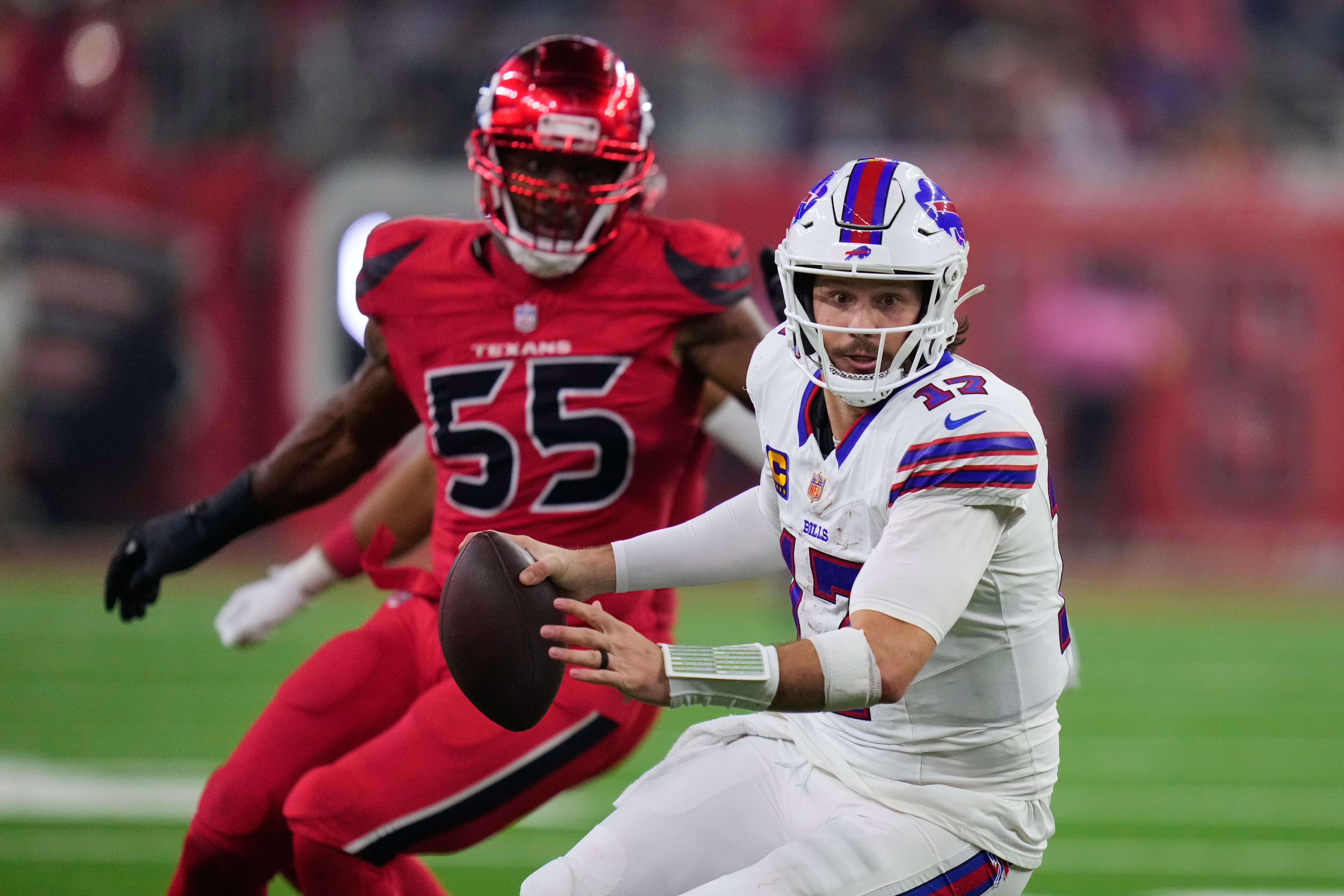Buffalo Bills quarterback Josh Allen (17) scrambles under pressure from Houston Texans defensive end Danielle Hunter (55) in the second half of an NFL football game Thursday, Nov. 20, 2025, in Houston. (AP Photo/Eric Christian Smith)