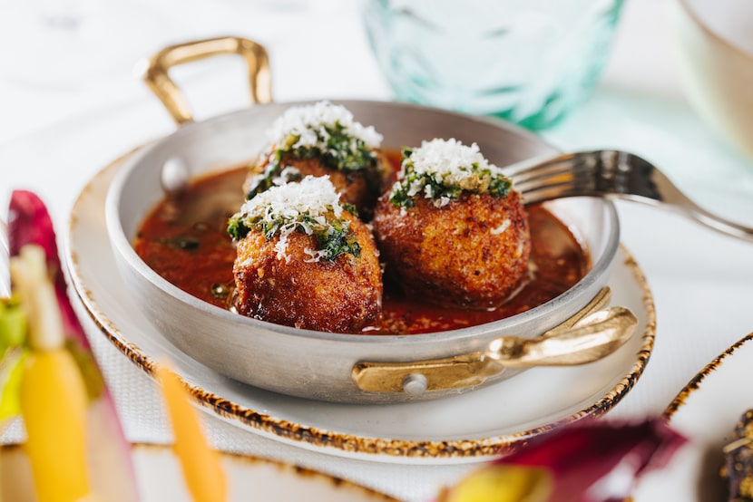 Arancini at 61 Osteria in Fort Worth is a blend of fontina cheese and rice, fried and topped...