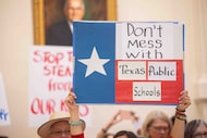 People protest school vouchers under the Capitol rotunda at the Texas State Capitol in...