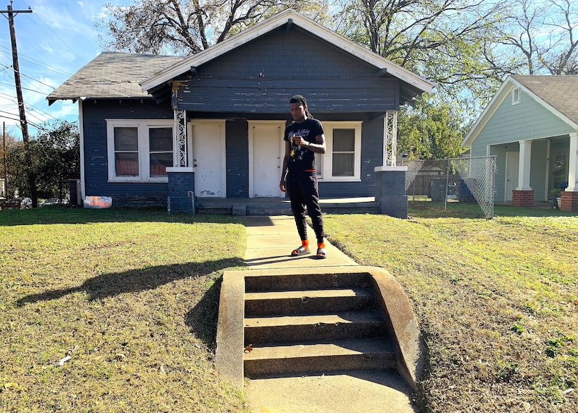 D.J. Smith-Rhodes stands in front of Ray Charles' former house on Eugene Street, where he...