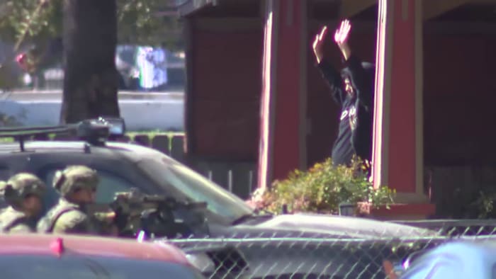 Man arrested, accused of pointing gun at officer at Airbnb property north of downtown