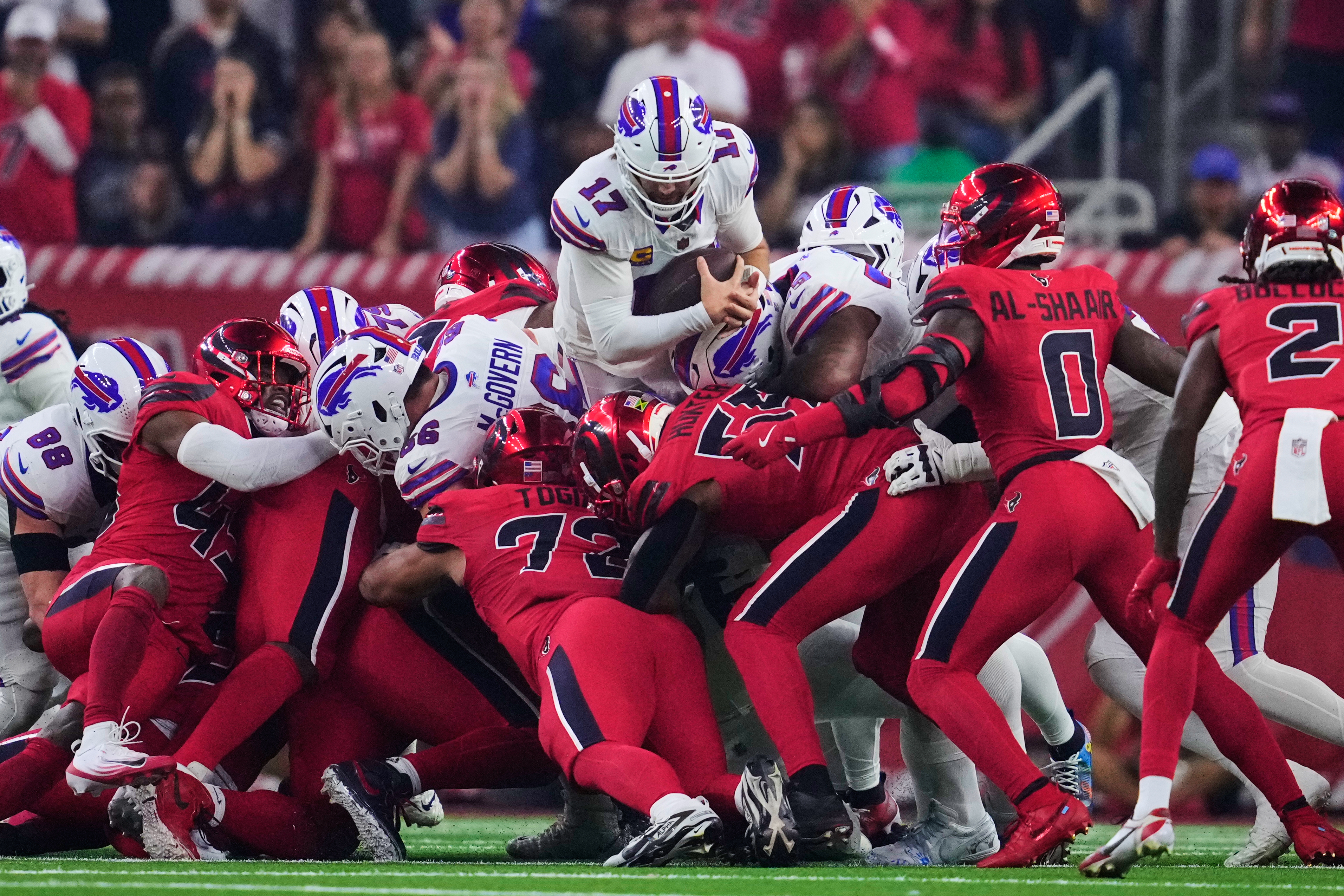 Buffalo Bills quarterback Josh Allen (17) leaps over the Houston Texans defense to earn a first down in the first half of an NFL football game Thursday, Nov. 20, 2025, in Houston. (AP Photo/Ashley Landis)
