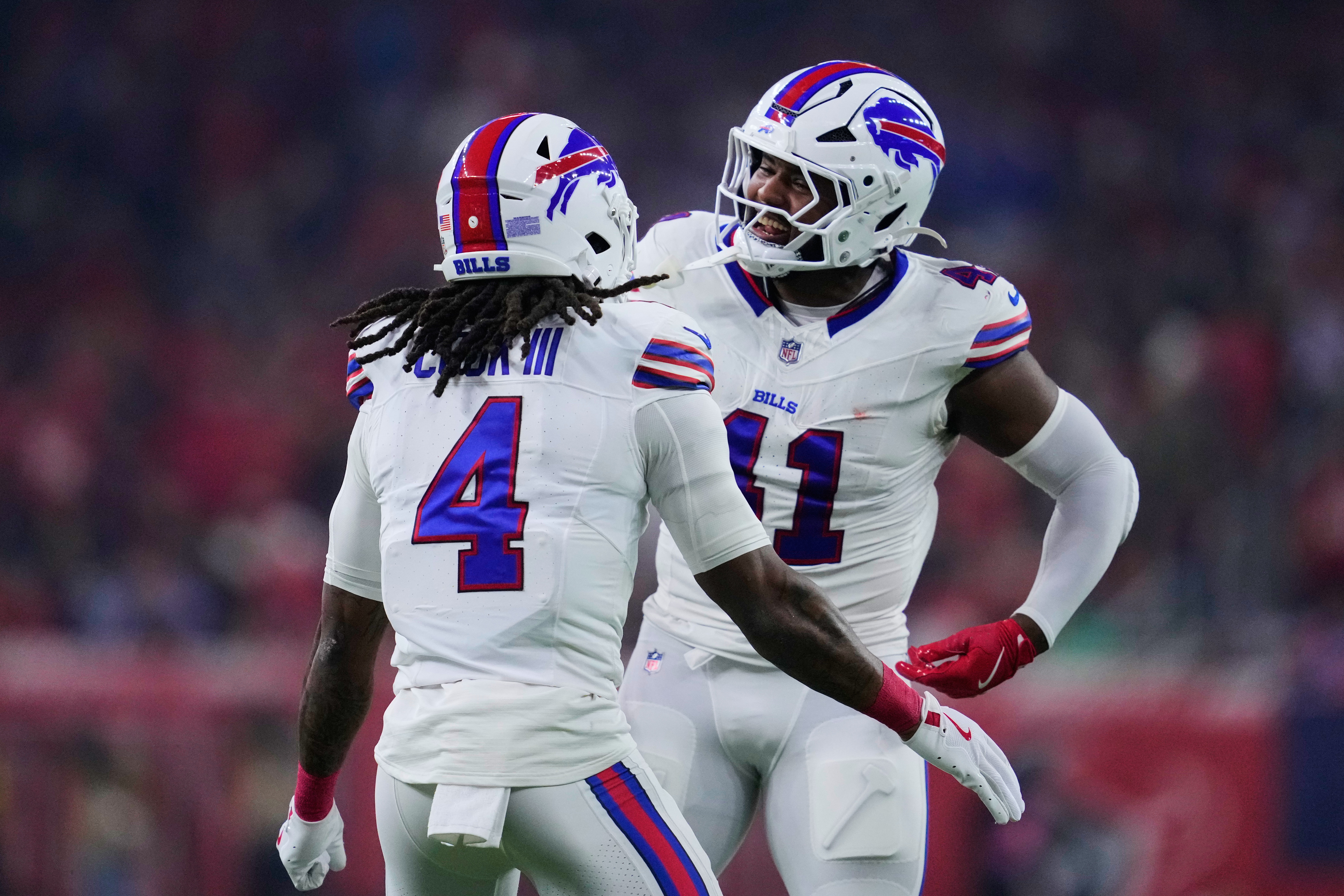 Buffalo Bills' James Cook III (4) and Reggie Gilliam, right, celebrate Cook's touchdown run in the first half of an NFL football game against the Houston Texans Thursday, Nov. 20, 2025, in Houston. (AP Photo/Ashley Landis)