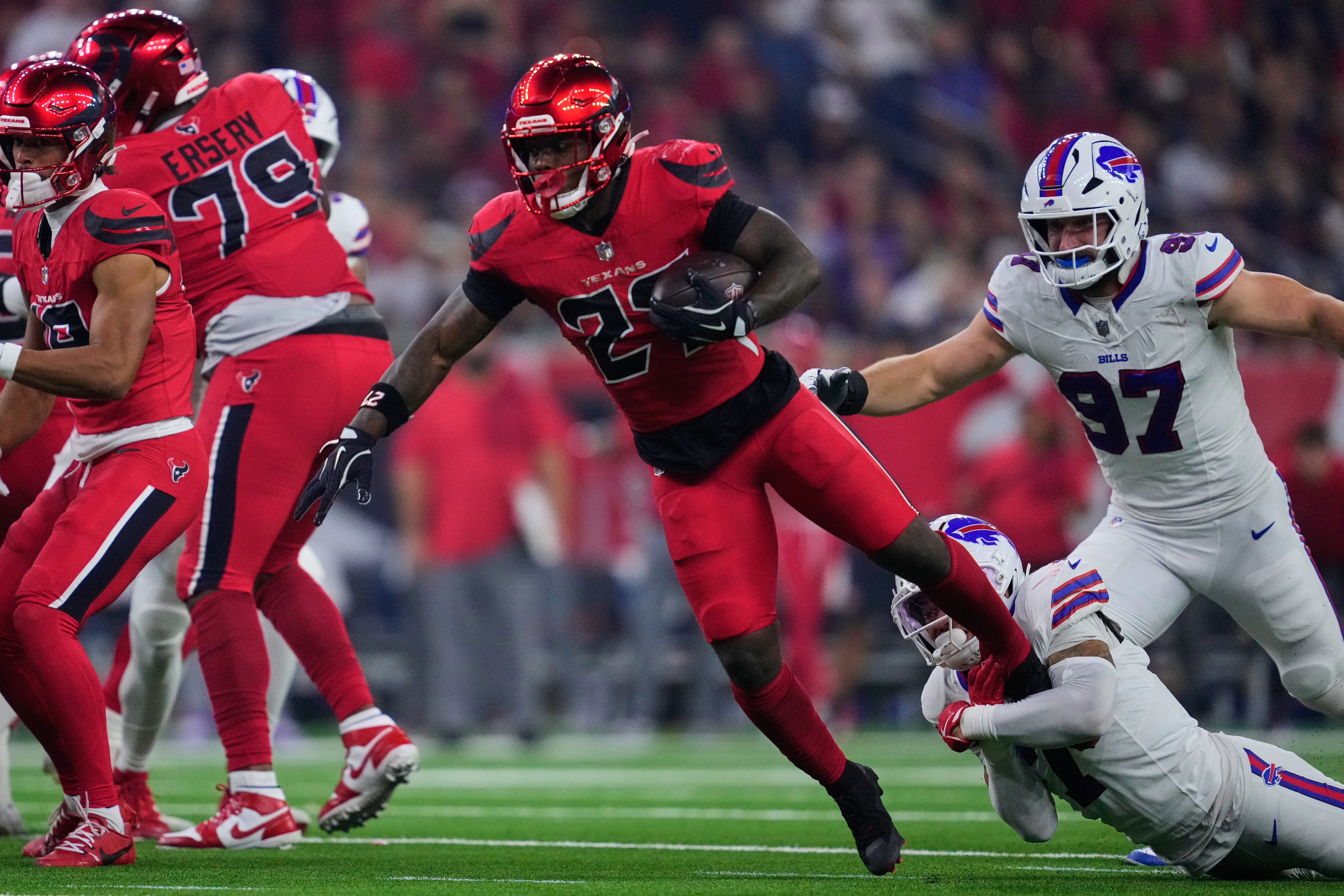 Houston Texans running back Woody Marks (27) is tackled by Buffalo Bills' Taron Johnson (7) in the first half of an NFL football game Thursday, Nov. 20, 2025, in Houston. (AP Photo/Ashley Landis)